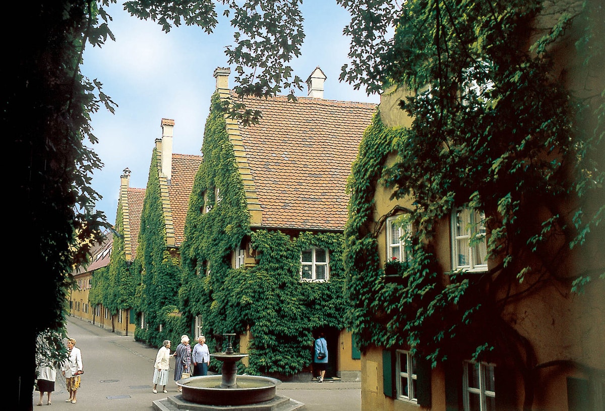 Fuggerei: The world's oldest social housing complex still in use. The enclave was built by the Renaissance merchant and banker Jakob Fugger the Younger in 1516.  The enclave in Augsburg still charges the same rent as in the 16th century. It requires individuals to conform to a series of common values and responsibilities in order to live in the urban enclave. Image: context medien und verlag Augsburg