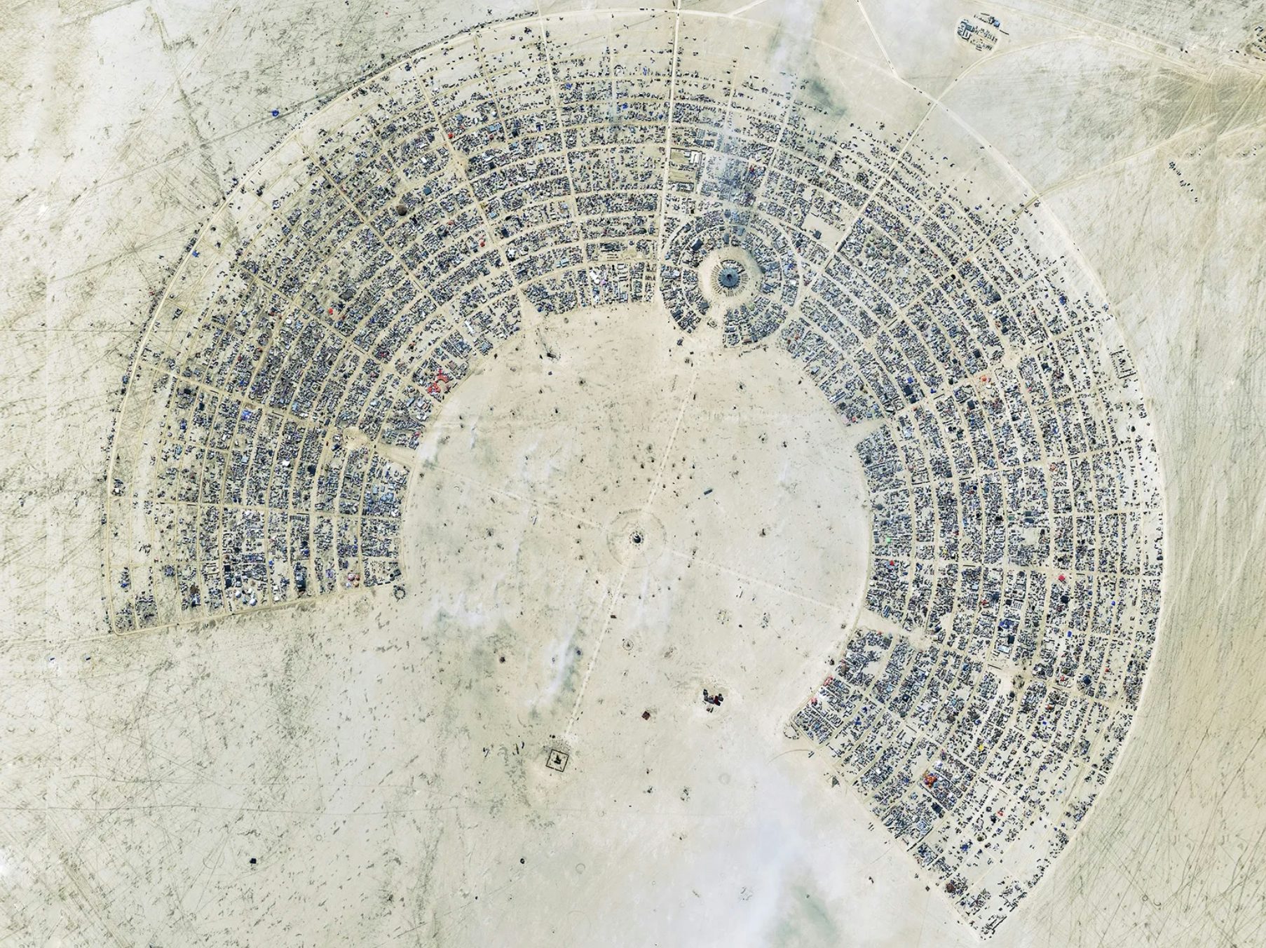 Black Rock City: A temporary settlement in the Nevada desert erected and taken apart every year, where people come together to freely associate in observance of ten principles: radical inclusion, gifting, de-commodification, radical self-reliance, radical self-expression, communal effort, civic responsibility, leaving no trace, participation, and immediacy. Image: Wired